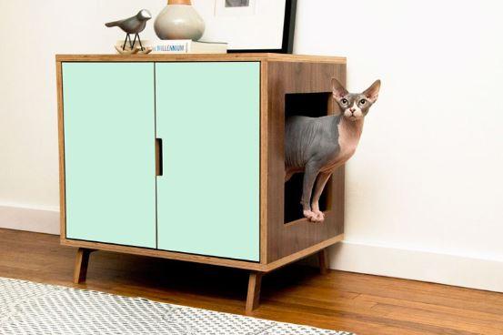 cat coming out of a cabinet